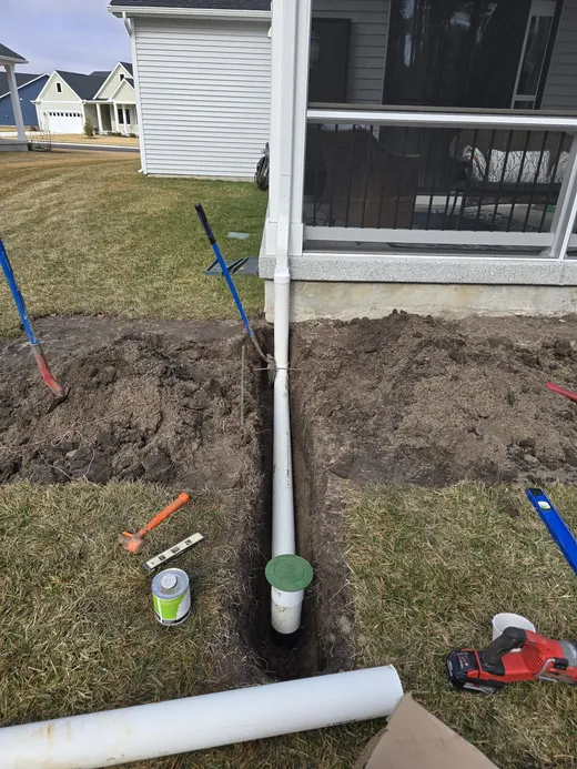 Underground downspout drain pipe installation trench