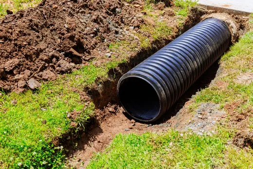 Corrugated drainage pipe laid in a trench