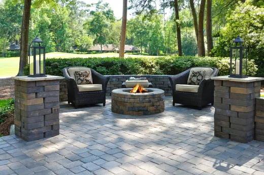 Paver patio with seating and a stone fire pit