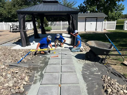Elzey Services crew installing a paver walkway and patio