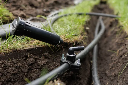 Irrigation line fitting and valve installed in a trench