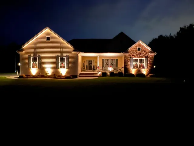 Landscape lighting installation on a home at night