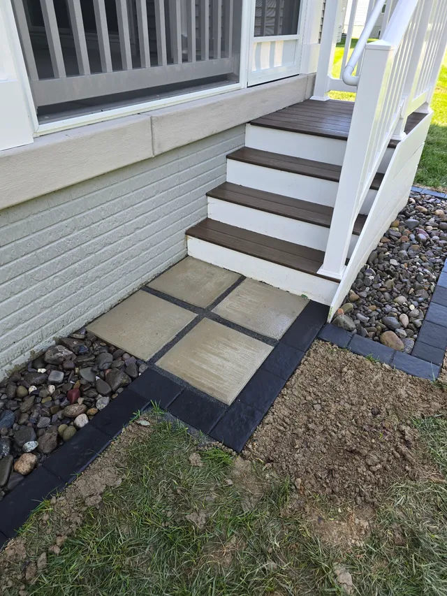Paver landing and drainage trench at a porch entrance