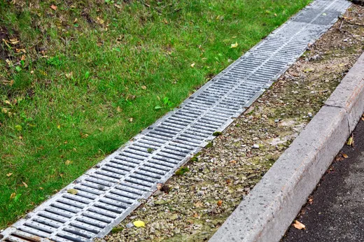 Yard drainage system channeling water away from a lawn — Elzey Services